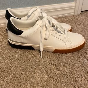 A New Day white and black tennis shoes.
